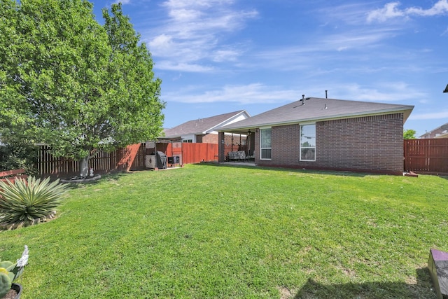 view of yard with a patio area and a fenced backyard