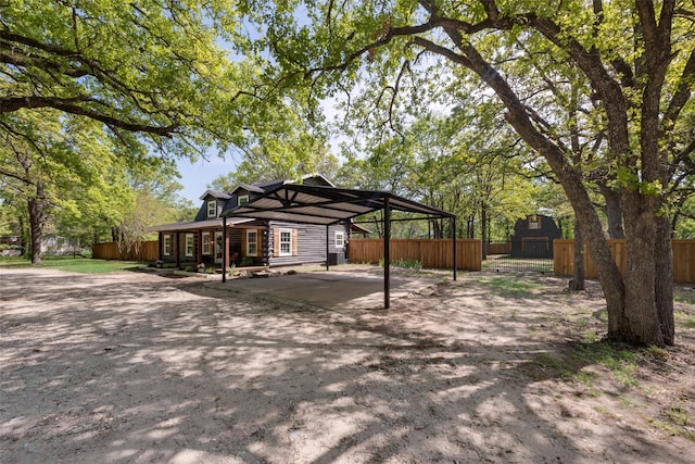 exterior space featuring a detached carport and fence