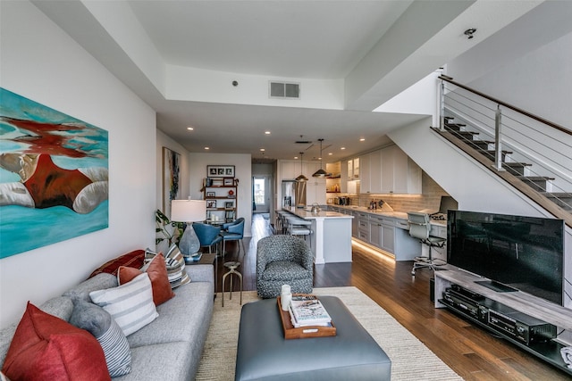 4611 Travis St Unit 1408B, Dallas, TX 75205 - living area featuring dark wood-style floors, stairs, and recessed lighting
