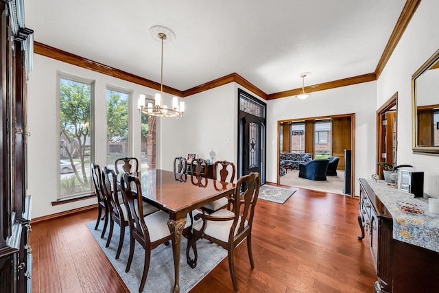 1409 Thames Dr, Plano, TX 75075 - dining area with a chandelier, wood-type flooring, baseboards, and crown molding