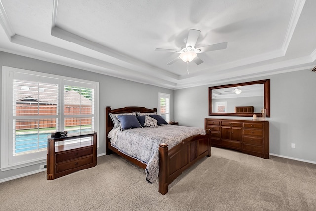 1409 Thames Dr, Plano, TX 75075 - bedroom with crown molding, light colored carpet, a ceiling fan, a raised ceiling, and baseboards