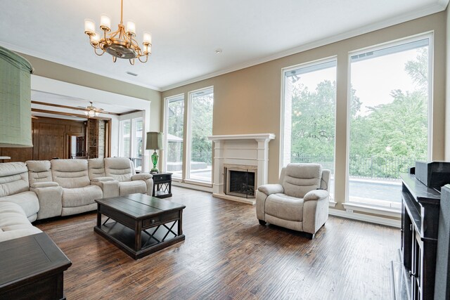 5 Cypress Ct, Heath, TX 75032 - living area featuring a fireplace, crown molding, a chandelier, wood finished floors, and a ceiling fan