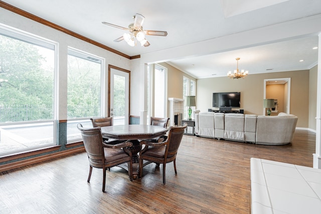 5 Cypress Ct, Heath, TX 75032 - dining space featuring wood finished floors, a fireplace, a chandelier, ornamental molding, and baseboards