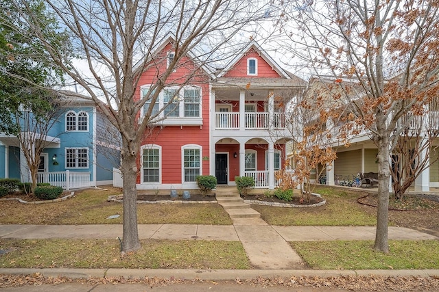 1153 King George Ln, Savannah, TX 76227 - view of front of house with a balcony, a porch, and a front lawn