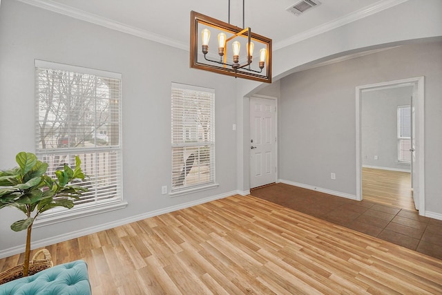 1153 King George Ln, Savannah, TX 76227 - unfurnished dining area with arched walkways, wood finished floors, crown molding, a chandelier, and baseboards