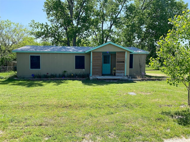 view of front of property with a front yard and fence