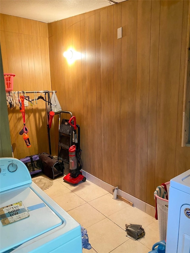 laundry area featuring tile patterned flooring, wooden walls, and laundry area