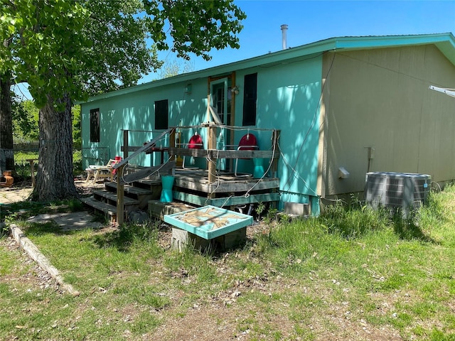 rear view of property featuring central air condition unit