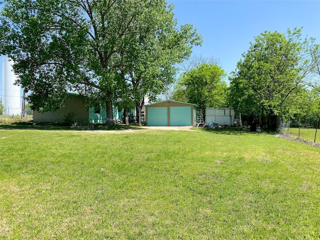 view of yard with an outbuilding and a garage