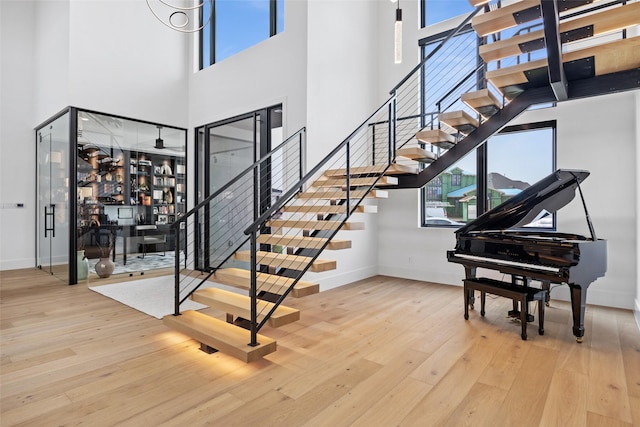 1284 Sunshine Ln, Southlake, TX 76092 - stairway featuring wood-type flooring, a high ceiling, and baseboards