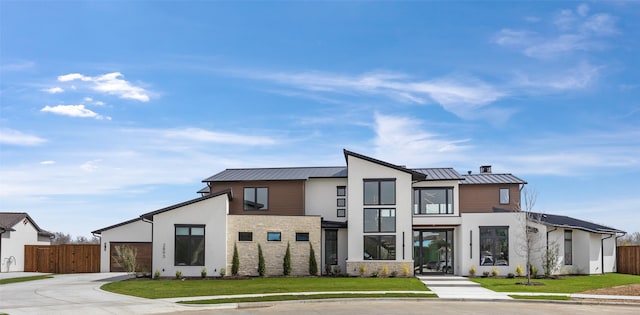 1284 Sunshine Ln, Southlake, TX 76092 - contemporary house featuring concrete driveway, an attached garage, a front yard, metal roof, and fence