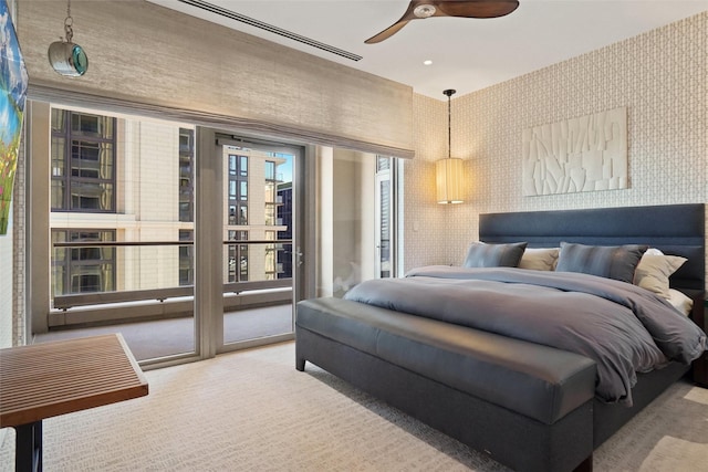 carpeted bedroom with access to exterior and ceiling fan