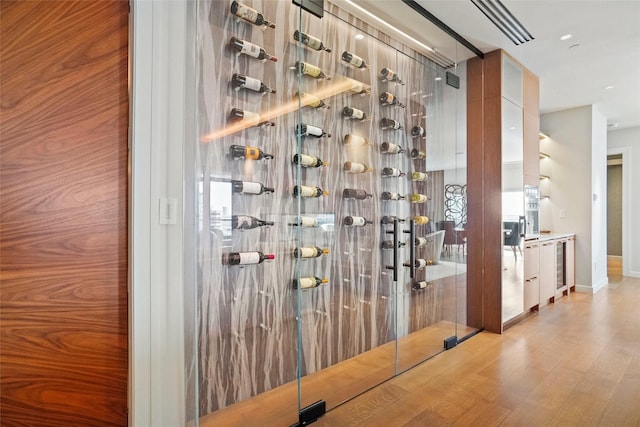 wine area featuring baseboards and wood finished floors