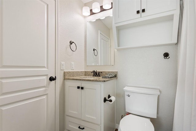 bathroom with toilet and vanity