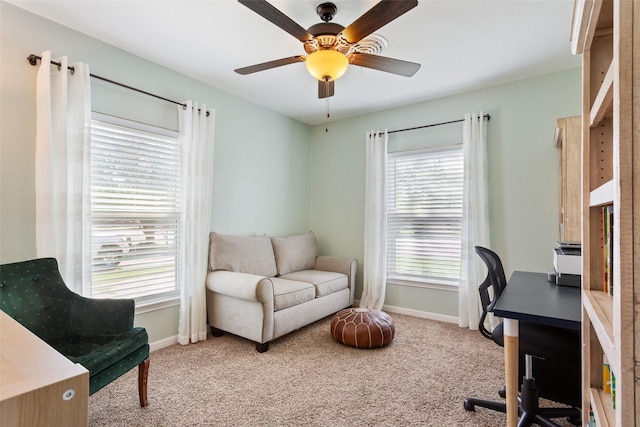 home office featuring light carpet, ceiling fan, and baseboards