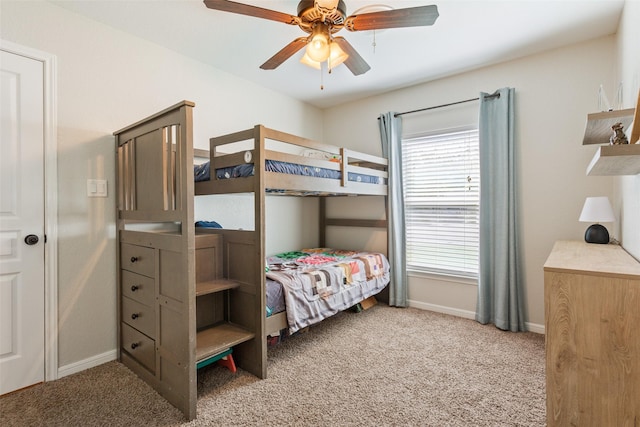 carpeted bedroom featuring baseboards and a ceiling fan
