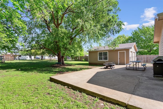 view of yard featuring a patio, a fire pit, a fenced backyard, and an outdoor structure