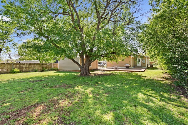 view of yard featuring a deck and fence