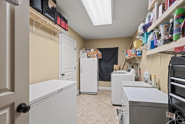 laundry area featuring light floors, independent washer and dryer, and laundry area