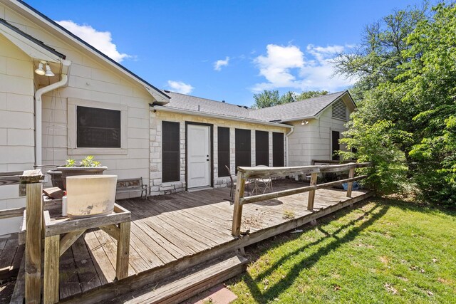 wooden terrace featuring a lawn