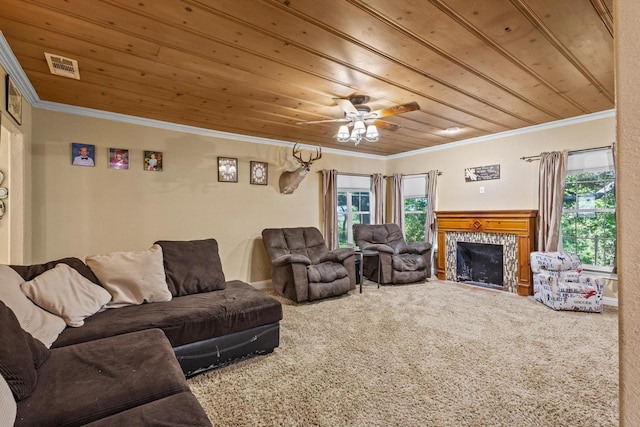carpeted living room with plenty of natural light, visible vents, crown molding, and wooden ceiling
