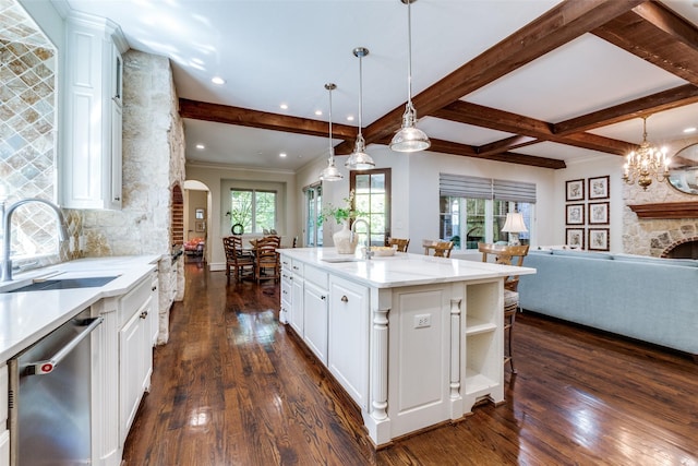 kitchen with stainless steel dishwasher, open floor plan, dark wood-style flooring, and a sink
