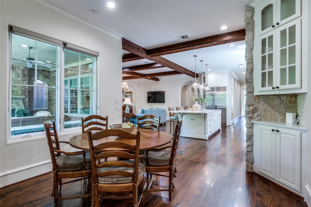 dining room featuring arched walkways, beamed ceiling, dark wood finished floors, and visible vents