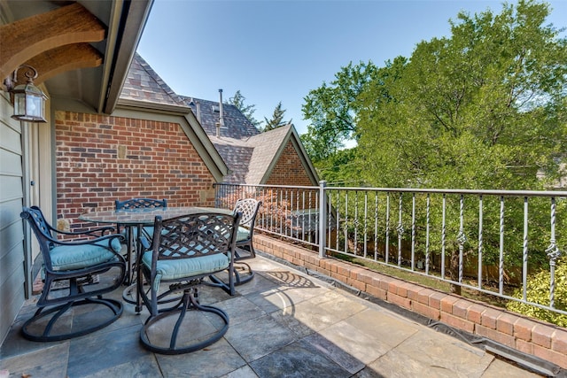 view of patio featuring outdoor dining area and a balcony