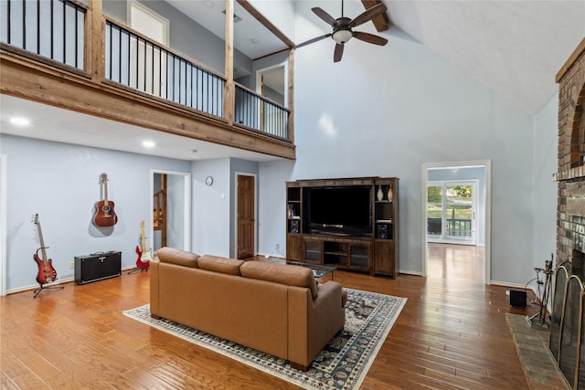 260 Winding Way, Fairfield, TX 75840 - living room with high vaulted ceiling, a fireplace, ceiling fan, hardwood / wood-style flooring, and baseboards