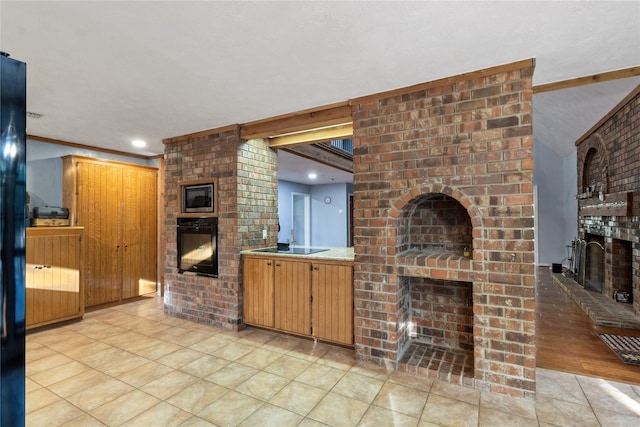 260 Winding Way, Fairfield, TX 75840 - kitchen with a brick fireplace, black appliances, light countertops, recessed lighting, and light tile patterned flooring