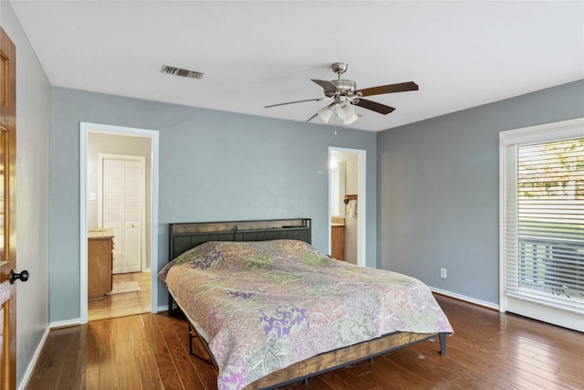 260 Winding Way, Fairfield, TX 75840 - bedroom featuring dark wood-style floors, baseboards, ceiling fan, and ensuite bath
