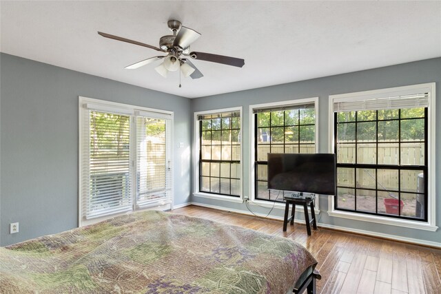 260 Winding Way, Fairfield, TX 75840 - bedroom featuring wood finished floors, multiple windows, access to outside, and baseboards
