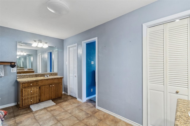 260 Winding Way, Fairfield, TX 75840 - bathroom with a closet, vanity, and baseboards