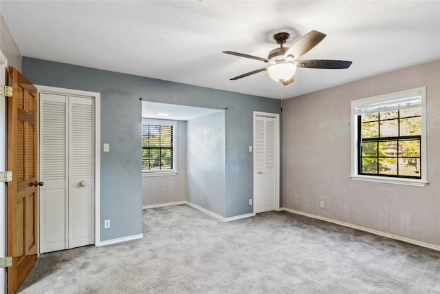 260 Winding Way, Fairfield, TX 75840 - unfurnished bedroom with carpet flooring, baseboards, ceiling fan, and multiple closets