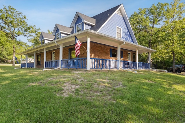 260 Winding Way, Fairfield, TX 75840 - view of side of property featuring covered porch, a lawn, and brick siding
