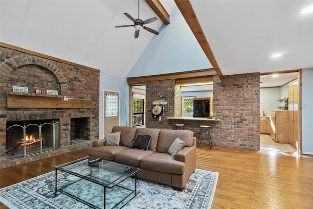 260 Winding Way, Fairfield, TX 75840 - living room with a fireplace, beam ceiling, a ceiling fan, wood finished floors, and high vaulted ceiling