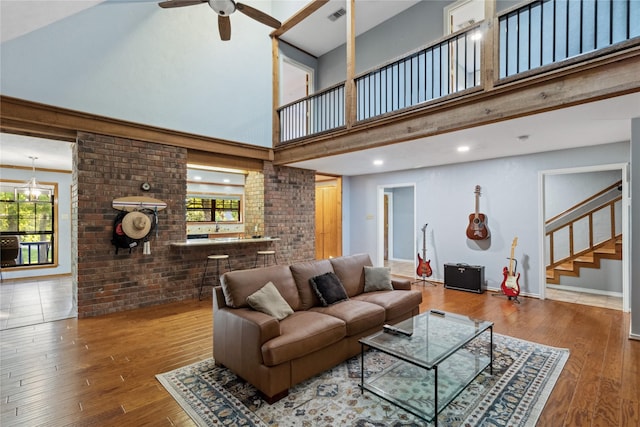 260 Winding Way, Fairfield, TX 75840 - living area featuring stairway, a towering ceiling, wood-type flooring, ceiling fan, and plenty of natural light