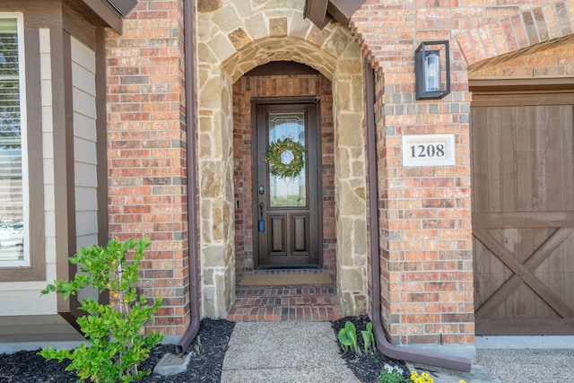 1208 Claire St, Lantana, TX 76226 - doorway to property featuring brick siding and a garage