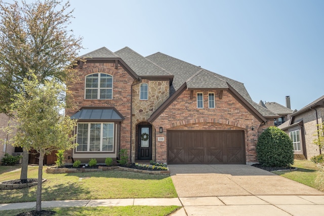 1208 Claire St, Lantana, TX 76226 - view of front of home featuring concrete driveway, a front lawn, roof with shingles, and brick siding
