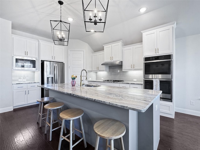 3906 Greenbrier Dr, Melissa, TX 75454 - kitchen featuring white cabinets, a chandelier, appliances with stainless steel finishes, a sink, and backsplash