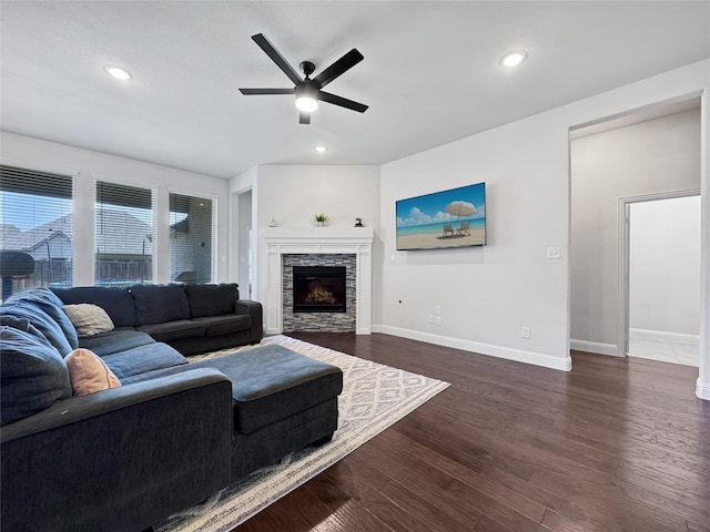 3906 Greenbrier Dr, Melissa, TX 75454 - living area featuring ceiling fan, baseboards, dark wood-style floors, and a stone fireplace