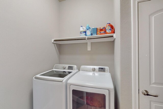 washroom with washing machine and dryer