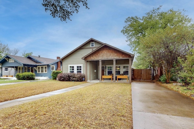 view of front of home featuring concrete driveway and a gate