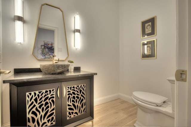 5919 Club Hill Pl, Dallas, TX 75248 - half bath featuring vanity, baseboards, toilet, and wood finished floors