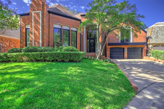 5919 Club Hill Pl, Dallas, TX 75248 - view of front of house featuring a front yard, an attached garage, aphalt driveway, a balcony, and brick siding