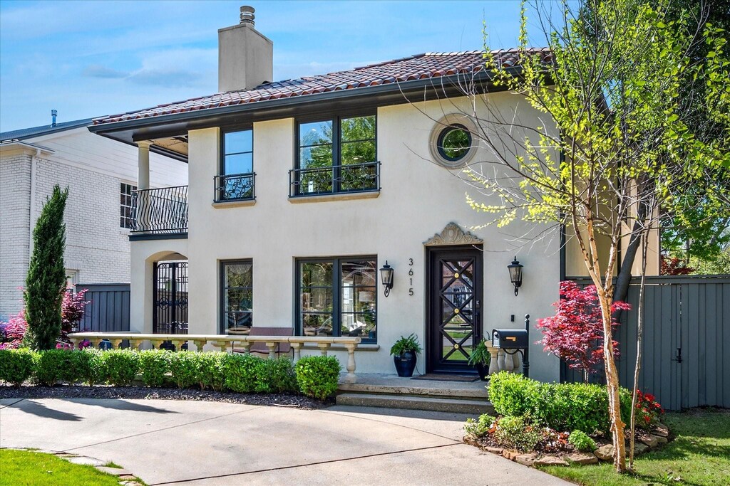 3615 University Blvd, University Park, TX 75205 - view of front of home with stucco siding, a tiled roof, fence, and a chimney