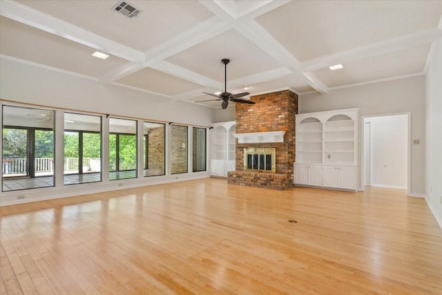 10010 Lost Oak Ridge Dr, Woodway, TX 76712 - unfurnished living room with a ceiling fan, light wood-style flooring, coffered ceiling, a brick fireplace, and beam ceiling