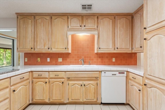 10010 Lost Oak Ridge Dr, Woodway, TX 76712 - kitchen featuring dishwasher, a sink, backsplash, and light tile patterned floors