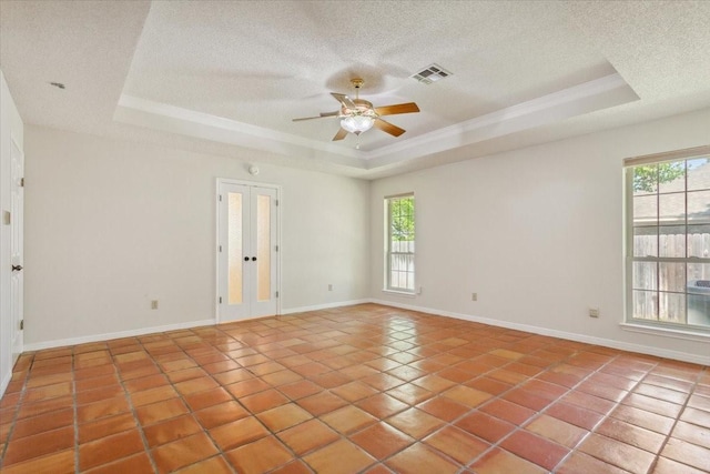 10010 Lost Oak Ridge Dr, Woodway, TX 76712 - unfurnished room with a raised ceiling, healthy amount of natural light, a textured ceiling, a ceiling fan, and french doors