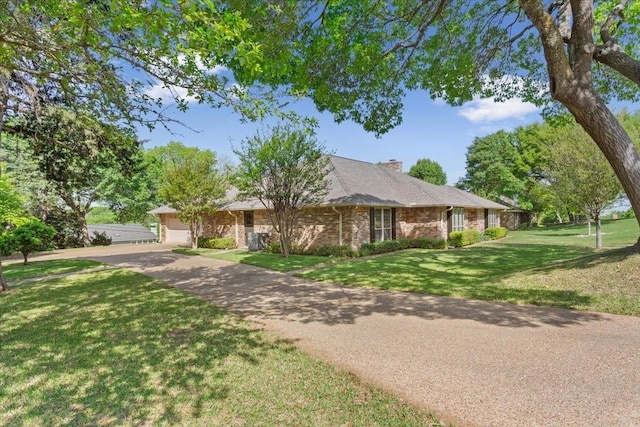 10010 Lost Oak Ridge Dr, Woodway, TX 76712 - ranch-style house featuring concrete driveway, a front lawn, brick siding, a garage, and a chimney